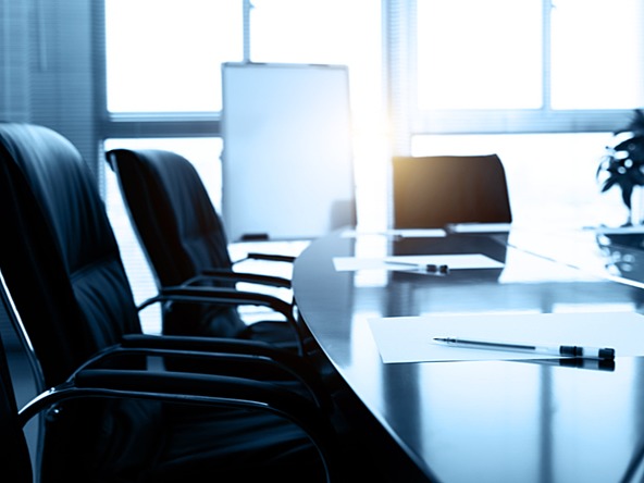boardroom chairs and table with notebook and pen